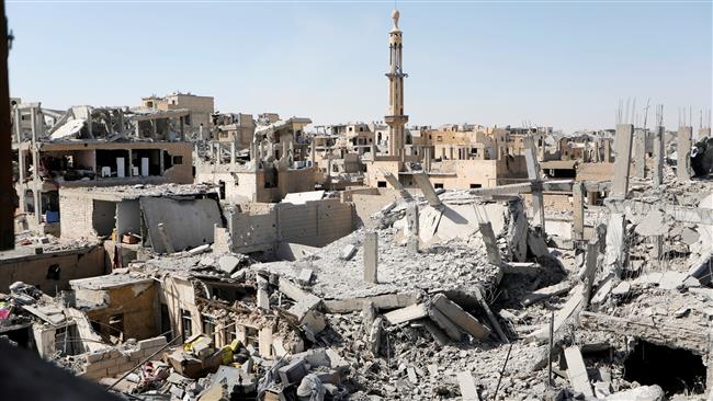 Buildings damaged in US-led airstrikes against the militant-held northern Syrian city of Raqqah are pictured on August 19, 2017 as fighting continues between US-backed militiamen from the so-called Syrian Democratic Forces (SDF) and Daesh Takfiri militants. (Photo by Reuters)