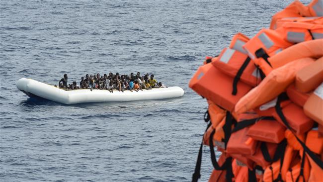 This file photo shows refugees on a rubber boat waiting to be evacuated during a rescue operation by the crew of the Topaz Responder, a rescue ship run by Maltese NGO in waters off Libya. (By AFP)