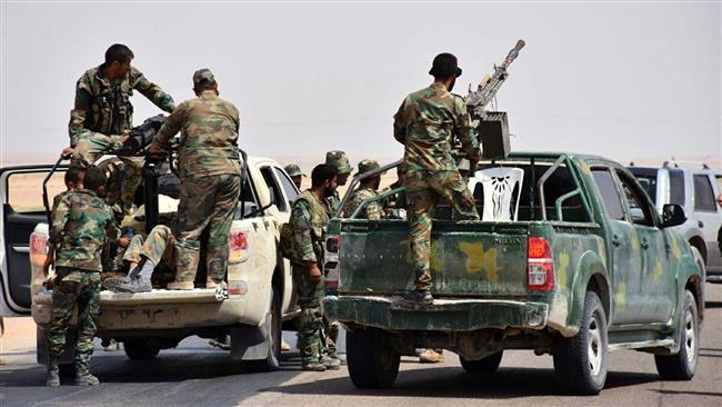 Syrian army troops and pro-government fighters stand on pickup trucks with heavy machine-guns mounted on them, in the eastern city of Dayr al-Zawr, Syria, on September 4, 2017. (Photo by Syria’s official news agency SANA)