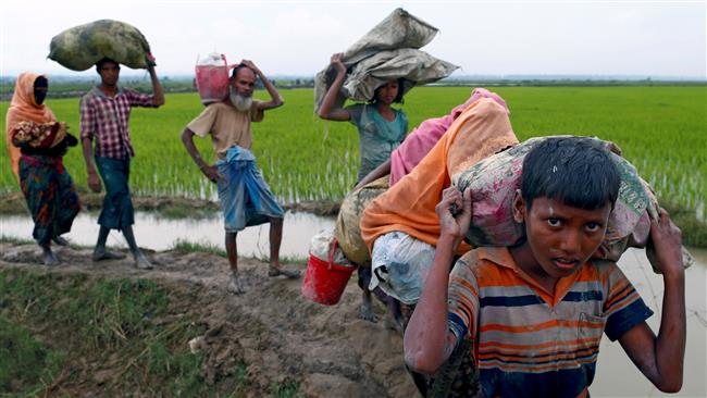 Rohingya Muslim refugees walk on a muddy path after crossing the Bangladesh-Myanmar border in Teknaf, Bangladesh, September 6, 2017. (Photo by Reuters)