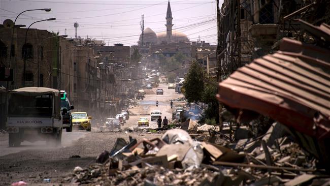 Cars drive along a damaged street in west Mosul on July 12, 2017, a few days after the government’s announcement of the liberation of the embattled city from Daesh terrorists. (Photo by AFP)