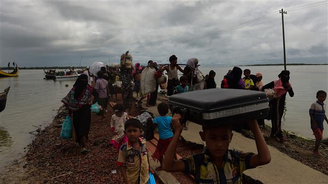 Rohingya Muslim refugees arrive from Myanmar after crossing the Naf river in the Bangladeshi town of Teknaf on September 12, 2017. (Photo by AFP)