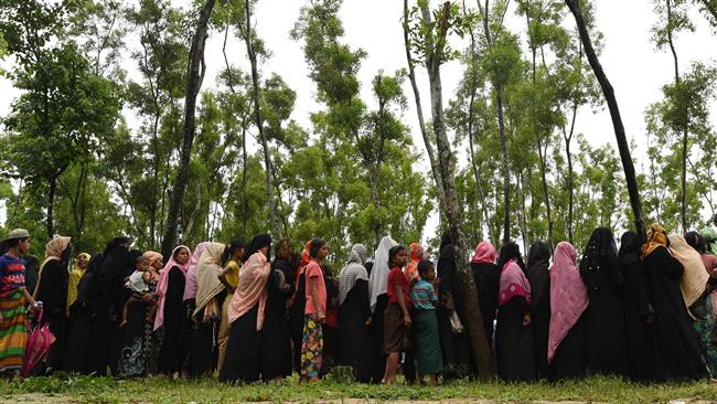 Rohingya Muslim refugees wait in line for relief supplies in the refugee camp of Leda near Teknaf in Bangladesh on September 19, 2017. (Photo by AFP)