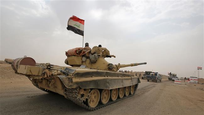 Iraqi soldiers ride atop a T-72 tank towards the city of al-Sharqat on September 20, 2017, as they are preparing to liberate the Daesh-held city of Hawijah in the northern province of Kirkuk. (Photo by AFP)