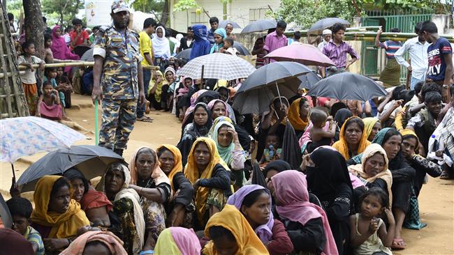 Newly-arrived Rohingya Muslim refugees wait in line for their registration at a government office in the Bangladeshi town of Ukhia on September 15, 2017. (Photo by AFP)