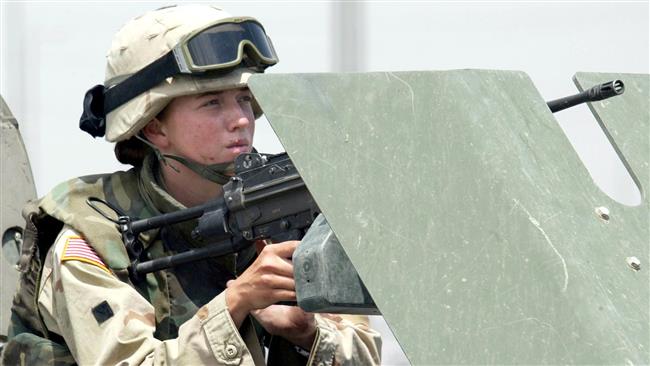 This 2003 AFP file photo shows a female US military soldier manning a machine gun in the northern Iraqi city of Mosul.