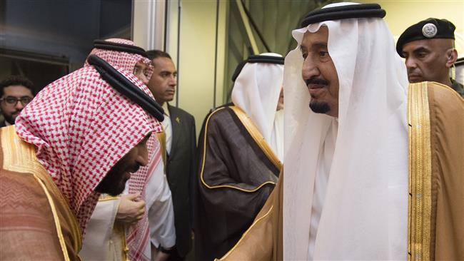 A handout picture provided by the Saudi Royal Palace on August 23, 2017 shows Saudi King Salman (R) being welcomed by his son Deputy Crown Prince and Defence Minister Mohammed bin Salman (L) at Jeddah airport upon his return from holiday in Morocco. (Photo by AFP)