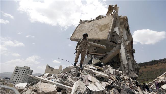 A Yemeni soldier stands on the debris of a house destroyed by a Saudi airstrike in the capital Sana’a on August 26, 2017. (Photo by AFP)