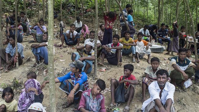 Rohingya Muslim refugees sit together at Bangladesh’s Balukhali refugee camp on October 2, 2017. (Photo by AFP)