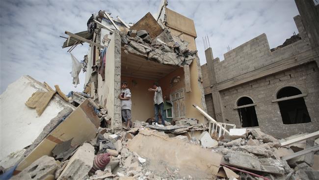 Boys stand on the rubble of a house destroyed by Saudi Arabia’s airstrikes in the Yemeni capital, Sana’a, on August 25, 2017. (Photo by AP)