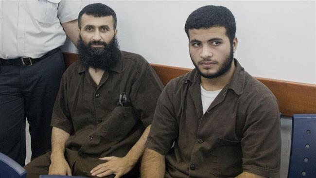 This file photo shows Palestinian Ziad Awad (L) and his son Izz Eddin at Israel’s Ofer military court in the occupied West bank, on June 23, 2014.