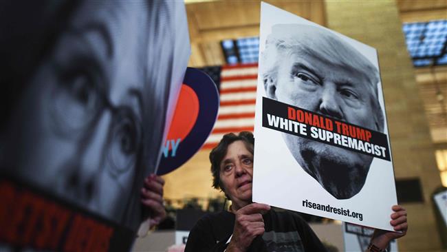 A protester displays a placard against US President Donald Trump during a “Rise and Resist Against White Supremacy” demonstration in New York, on September 18, 2017. (AFP photo)