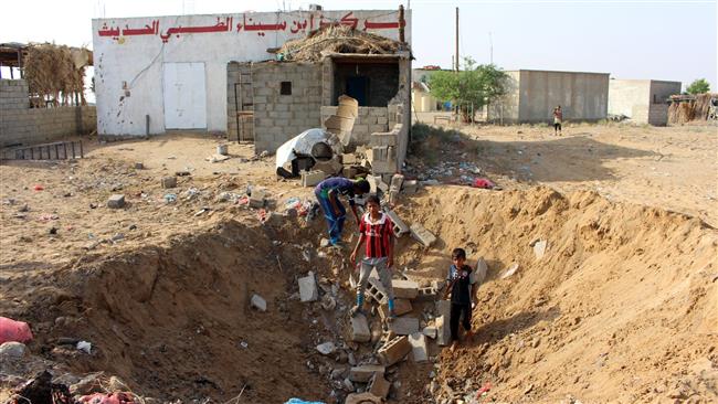 Yemeni children gather at a crater left at the site of a Saudi airstrike against a health center in the Abas district of Yemen’s northern province of Hajjah on October 7, 2017. (Photo by AFP)