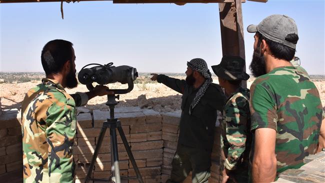 Syrian government forces keep watch from a position in the eastern Syrian city of Dayr al-Zawr on September 11, 2017, as they continue to press forward under Russian air cover in an offensive against Daesh across the province. (Photo by AFP)