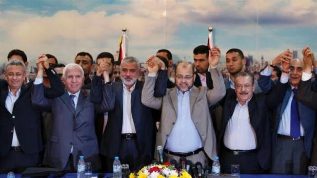 Palestinian officials of rival Hamas and Fatah parties hold hands in a sign of national unity in Cairo, Egypt, in this photo released by Palestinian media on October 12, 2017.