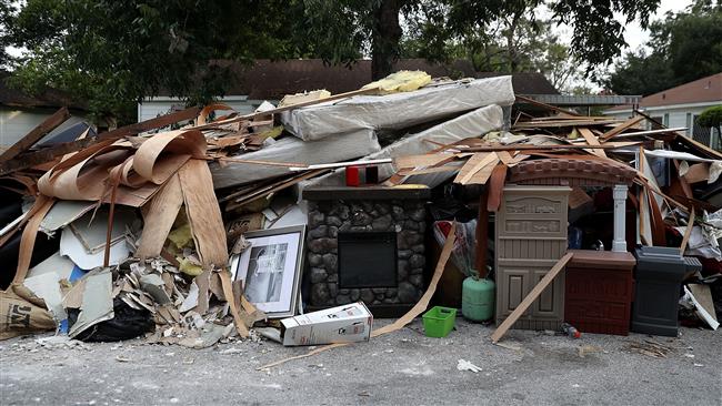 A fireplace sits in the middle of a trash pile in front of a flood damaged home on September 5, 2017, in Houston, Texas. (Getty Images)