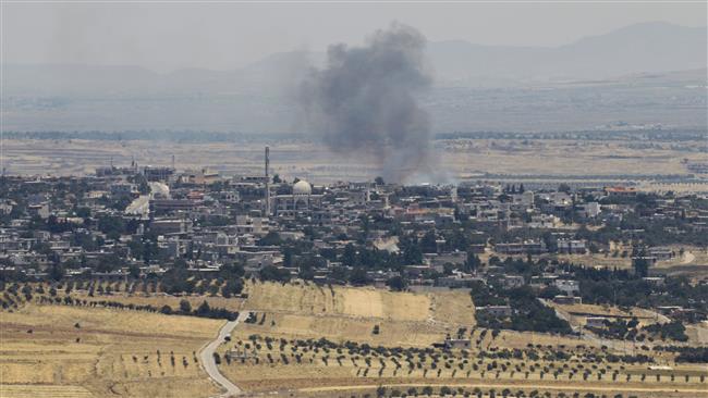 The picture, taken from the Israeli-occupied Golan Heights, shows smoke billowing from Syria on June 26, 2017. (By AFP)
