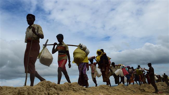 Rohingya refugees fleeing violence in Myanmar walk near the no-man’s land area between Bangladesh and Myanmar, in the Palongkhali area next to Ukhia, October 19, 2017. (Photo by AFP)