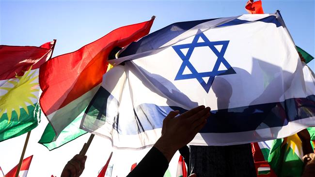 A picture taken on October 21, 2017 shows a man holding the Israeli flag as others raise the flag of Iraqi Kurdistan during a demonstration outside the UN Office in Erbil, the capital of the autonomous region. (By AFP)