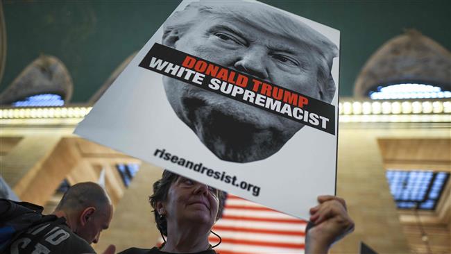A protester displays a placard against US President Donald Trump during a demonstration against white supremacy inside the Grand Central Station in New York on September 18, 2017. (AFP photo)