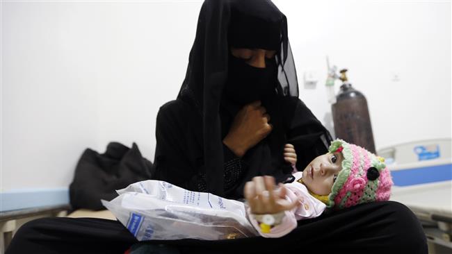 A Yemeni woman holds her child, who is suspected of being infected with cholera, at a makeshift hospital in the capital Sana’a, on August 12, 2017. (Photo by AFP)