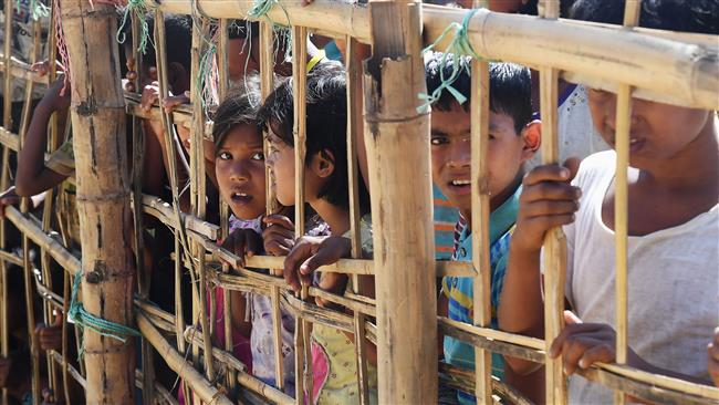 Young Rohingya Muslim refugees look on through a temporary bamboo barricade at the Thankhali refugee camp in Bangladesh, November 10, 2017. (Photo by AFP)