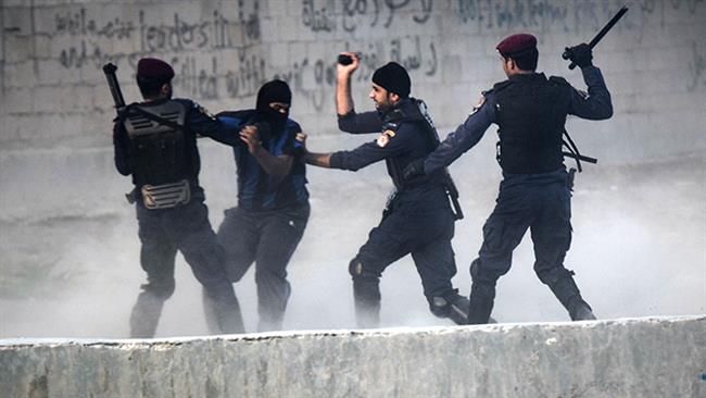 In this file photo, Bahraini police force arrest a protester during a demonstration against the ruling regime in the village of Shakhurah, west of Manama. (Photo by AFP)