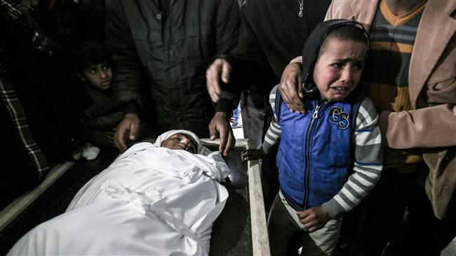 Palestinian children mourn next to the body of 18-year-old Youssef Abou Azra during his funeral in Rafah in the southern Gaza Strip on March 22, 2017. (Photo by AFP)