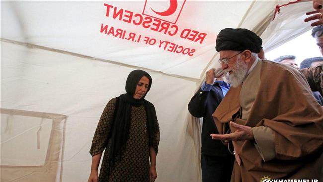 Ayatollah Khamenei speaks to a local woman inside a Red Crescent tent during a visit to the quake-hit Kermanshah Province on November 20, 2017.