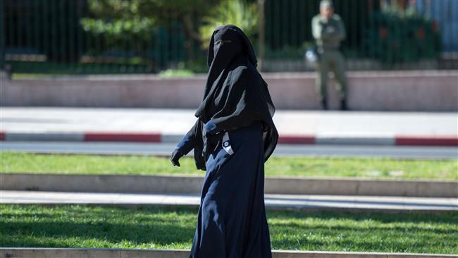 This file photo taken on January 15, 2017 shows a woman wearing a niqab walking along a street in the Moroccan capital, Rabat. (By AFP)