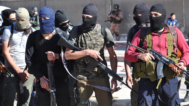 Syrian militants arrive at a checkpoint ahead of their evacuation from the Waer neighborhood, the last terrorist-held district in the central city of Homs, on May 21, 2017. (Photo by AFP)