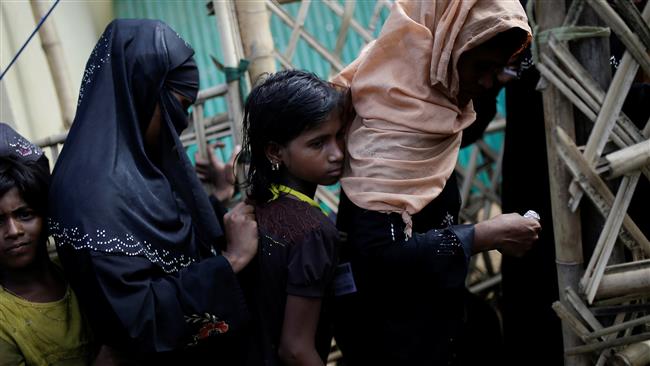 Rohingya refugee women and girls wait for blankets to be distributed at the Kutupalong camp near Cox’s Bazar, Bangladesh, December 10, 2017. (Photo by Reuters)