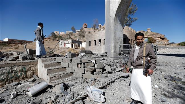 Yemeni men look at the damage in the aftermath of an airstrike by the Saudi-led coalition on a TV station in the capital, Sana’a, December 9, 2017. (Photo by AFP)