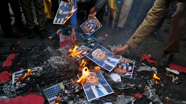 Portraits of US President Donald Trump burn during a demonstration in the Iranian capital, Tehran, on December 11, 2017 to denounce his declaration of Jerusalem as Israel’s “capital.” (Photo by AFP)