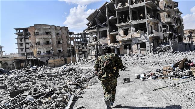 A member of the so-called Syrian Democratic Forces (SDF) runs to take cover from sniper shots near the central hospital of Raqqah, Syria, on October 1, 2017. (AFP photo)