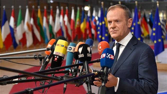 European Council President Donald Tusk answers the press as he arrives to attend the first day of a European council meeting in Brussels on December 14, 2017. (Photo by AFP)
