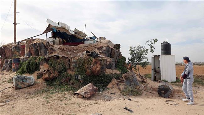 A Palestinian inspects damage to a Hamas post that was hit by Israeli tank and aircraft fire the previous night, east of the southern Gaza Strip city of Khan Yunis, on December 12, 2017. (Photo by AFP)