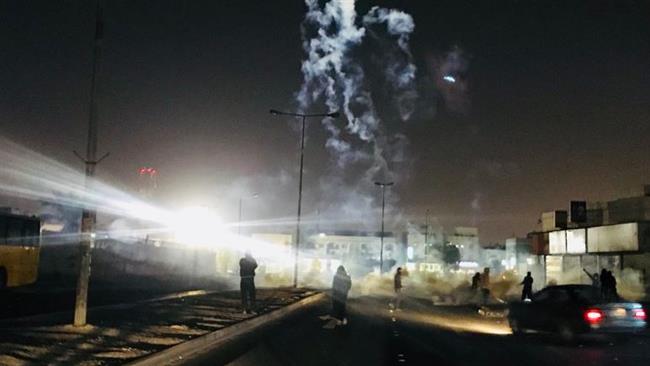 Plumes of tear gas are seen during clashes between Bahraini regime forces and protesters in Sitra on December 27, 2017.
