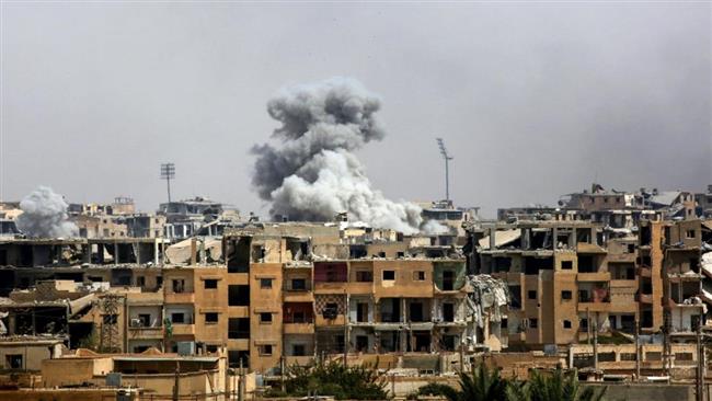 This photo taken on September 5, 2017, shows smoke billowing out following a US-led coalition airstrike in the western al-Daraiya neighborhood of the embattled northern Syrian city of Raqqah. (Photo by AFP)