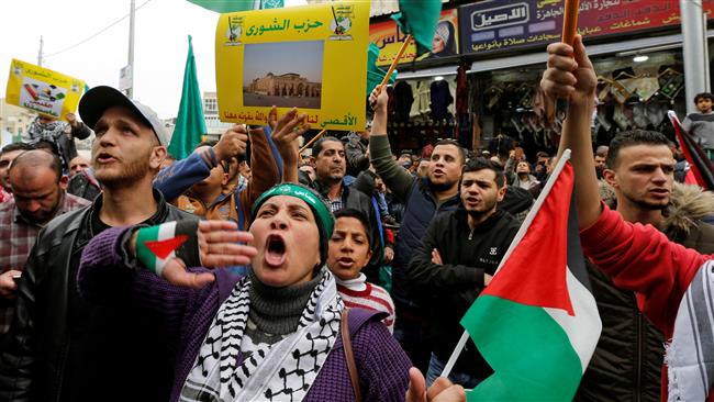 People chant slogans during a protest against US President Donald Trump