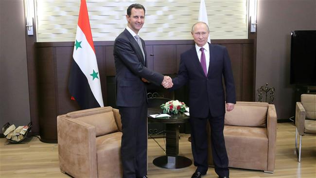 This file image shows Russian President Vladimir Putin (R) shaking hands with his Syrian President Bashar al-Assad during a meeting in the Russian resort city of Sochi on November 20, 2017. (By AFP)