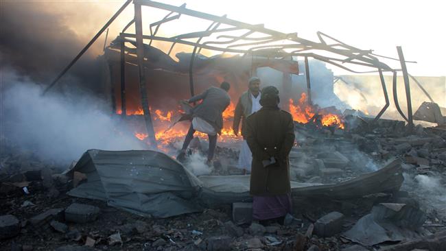 Smoke rises as Yemenis inspect the damage at the site of Saudi airstrikes in the northwestern city of Sa’ada on January 6, 2018. (Photo by AFP)