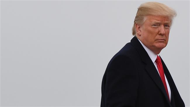 US President Donald J. Trump looks on before boarding Airforce One at Joint Base Andrews, Maryland on January 8, 2018. (Photo by AFP)