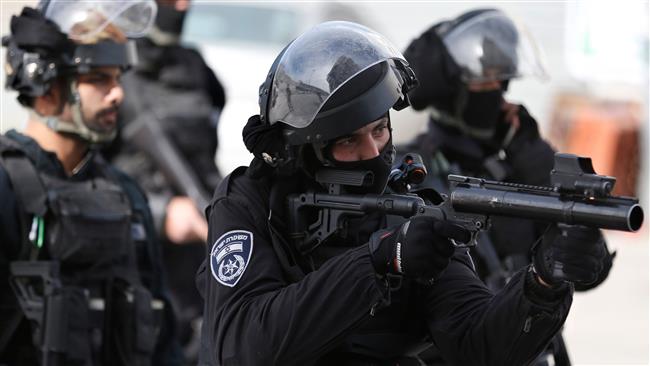 A member of the Israeli security forces aims his tear-gas launcher while patrolling a street where a home was demolished in a refugee camp in East Jerusalem al-Quds on December 5, 2017. (AFP photo)