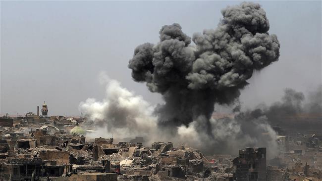 A picture taken on July 9, 2017, shows smoke billowing following an airstrike by US-led international coalition forces in Mosul, Iraq. (Photo by AFP)