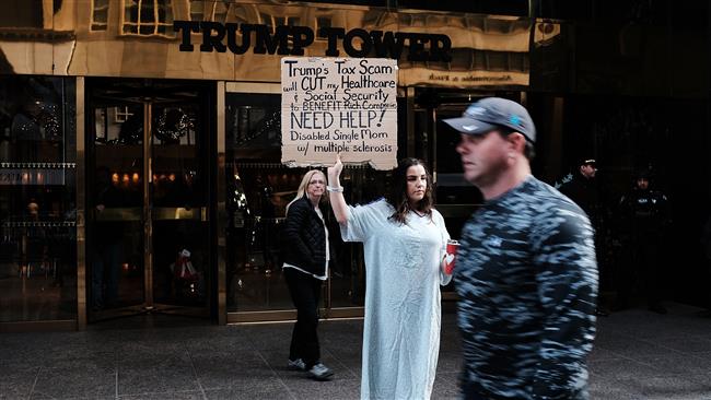 A woman, who has multiple sclerosis (MS) and fears for her finances, holds a protest outside of Trump Tower over the Republican administration’s proposed tax cut which many economists predict will benefit the wealthy at the expense of the poor and middle class on November 30, 2017 in New York City. (Photo by AFP)