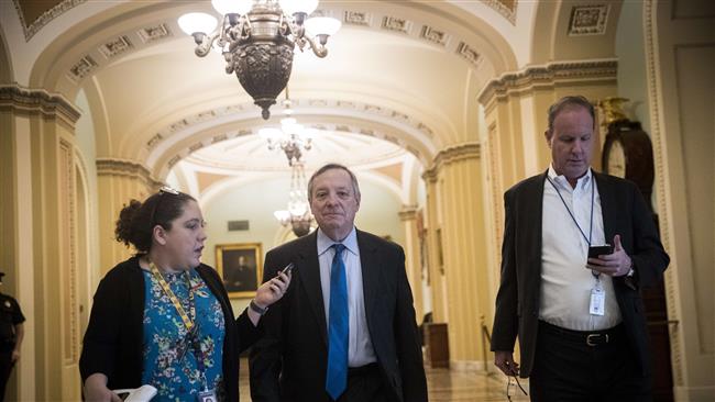 Sen. Dick Durbin (D-IL) walks to the office of Senate Minority Leader Chuck Schumer (D-NY) on Capitol Hill, January 21, 2018 in Washington, DC. (Photo by AFP)