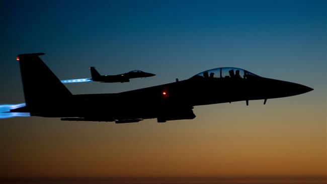 The file photo taken by the US Air Forces Central Command shows a pair of US Air Force F-15E warplanes flying over northern Iraq after conducting airstrikes in Syria. (Via AFP)