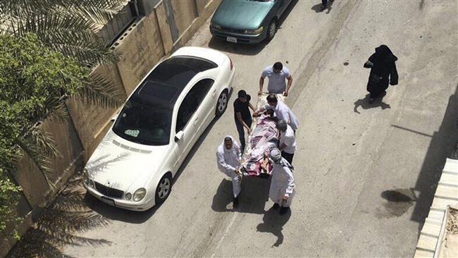 This image, provided by an activist who requested anonymity, shows people carrying a man injured in a raid on a sit-in in Diraz, Bahrain, on May 23, 2017. (Photo by AP)