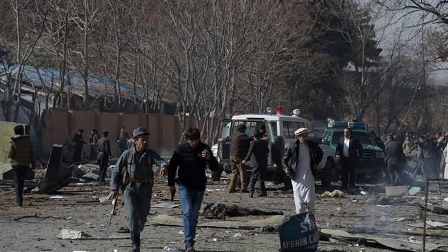 Afghan volunteers and policemen carry injured men on an ambulance at the scene of a car bomb explosion in front of the old building of the Interior Ministry in Kabul on January 27, 2018. (Photo by AFP)